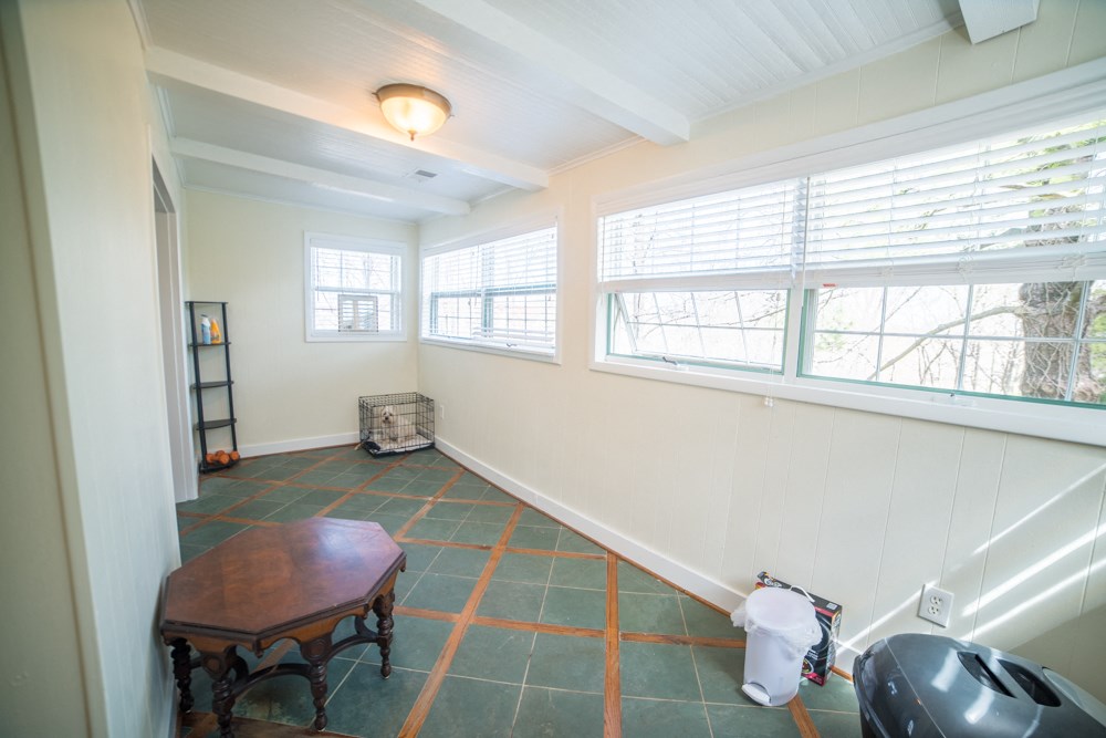 a living room with a large window and a table