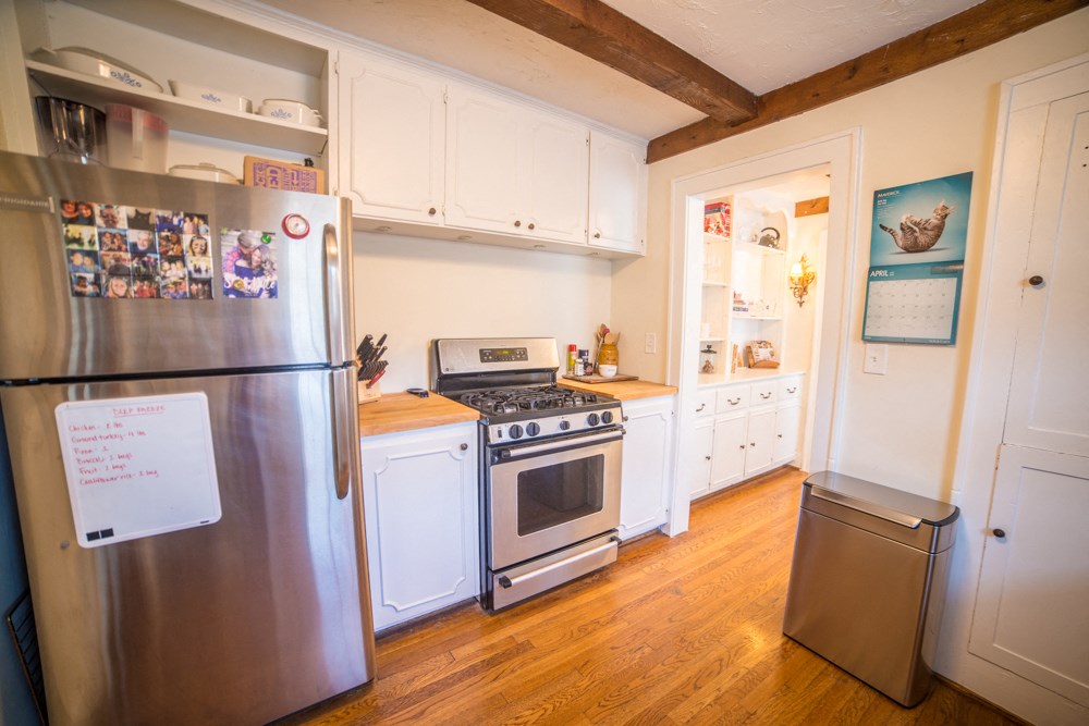 a kitchen with stainless steel appliances and white cabinets