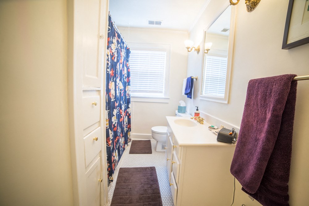 a bathroom with a shower and a sink and a toilet