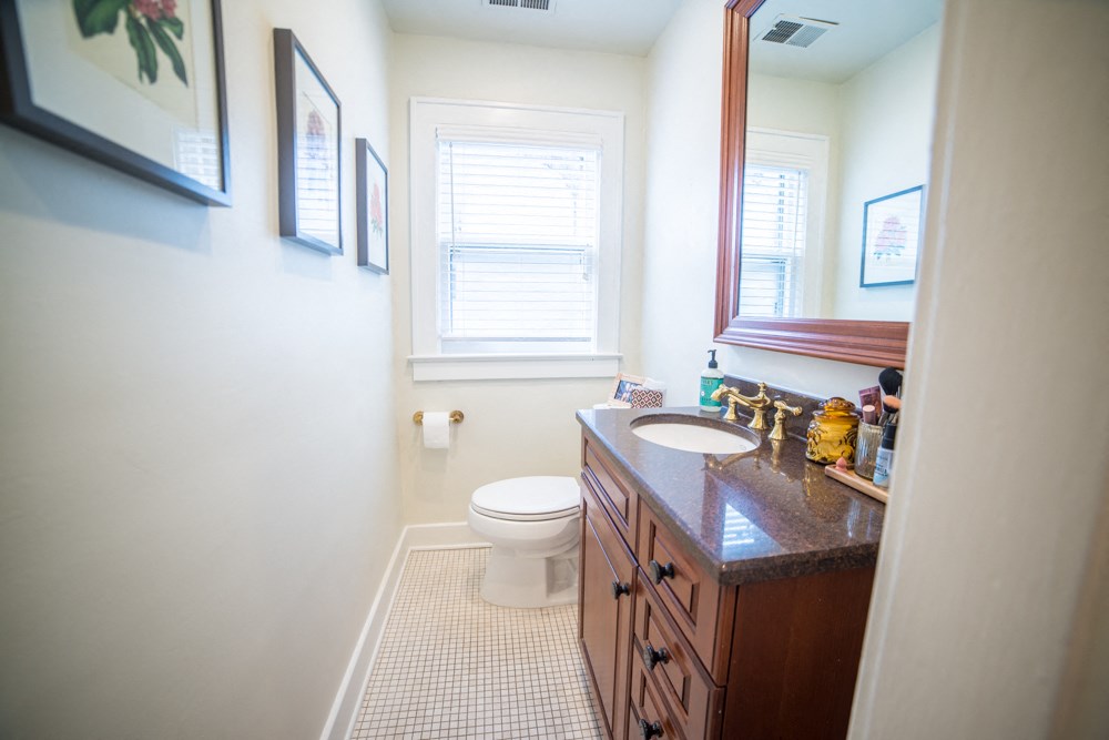 a bathroom with a toilet and a sink and a mirror