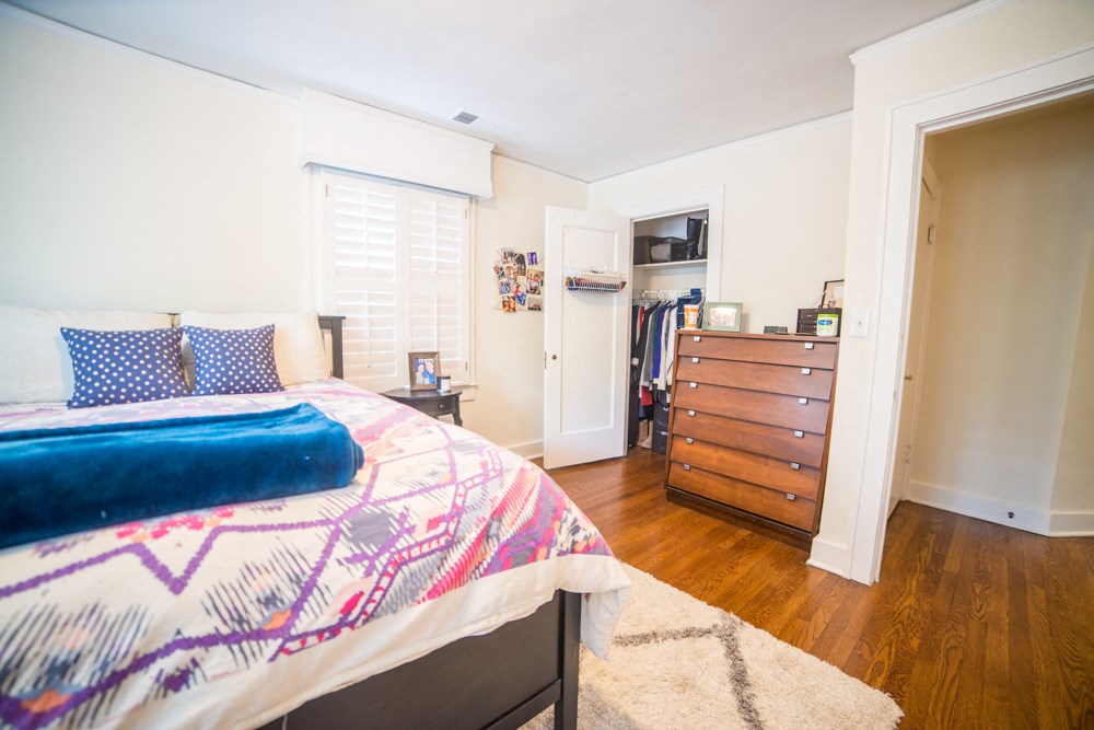 a bedroom with a bed and a dresser