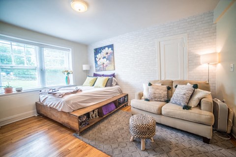 a bedroom with a bed and a couch