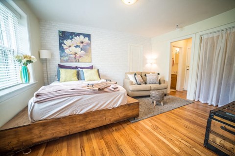 a bedroom with a bed and a couch