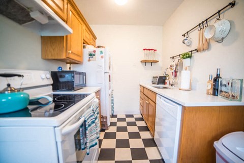 a small kitchen with a stove and a refrigerator
