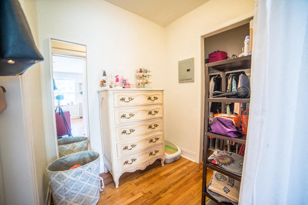 a bedroom with a dresser and a closet