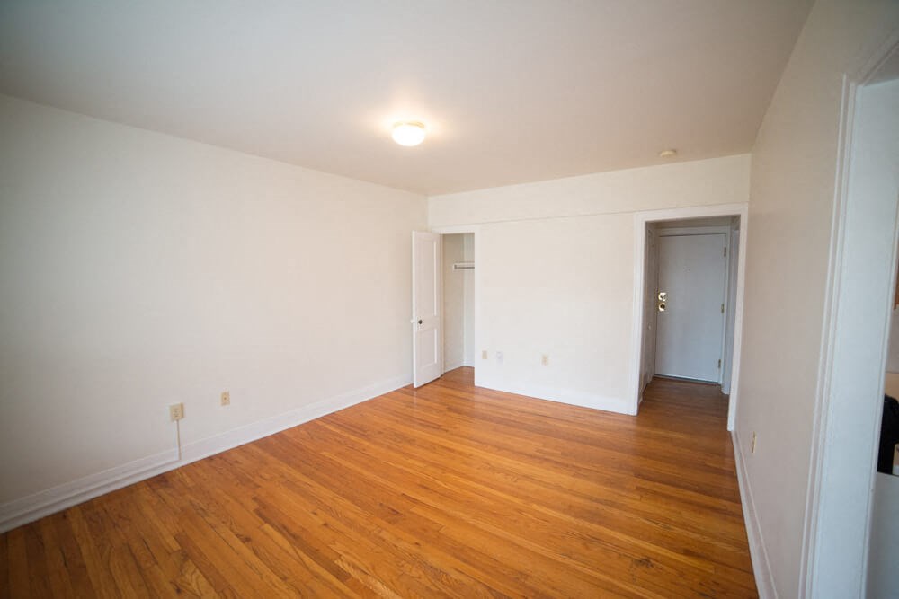 the living room and dining room of an empty house with wood floors