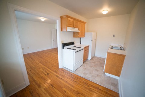 an empty kitchen with a stove and a refrigerator