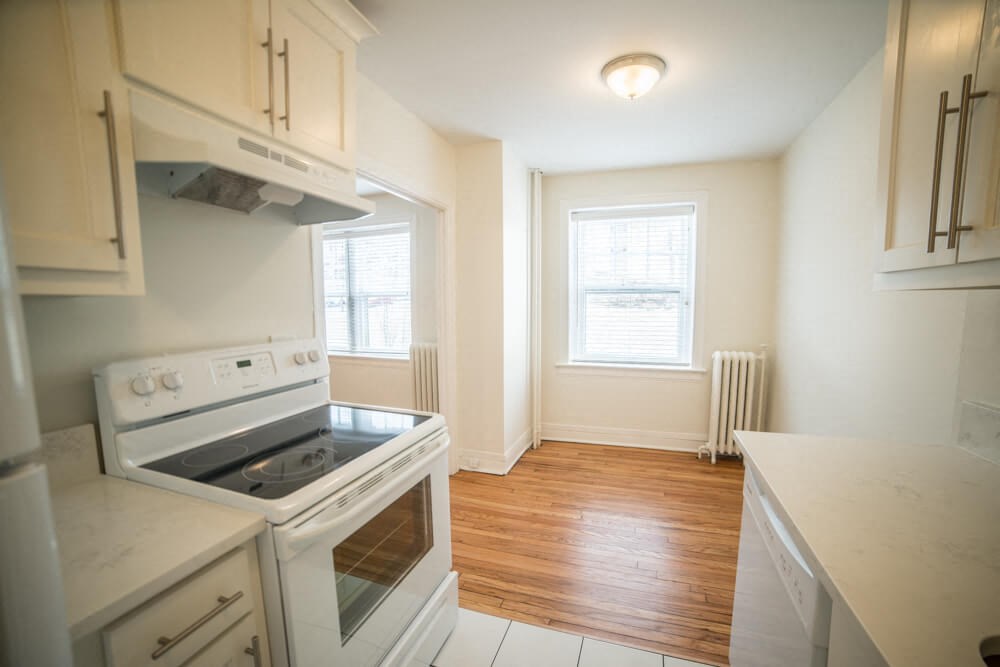 an empty kitchen with an oven and a window