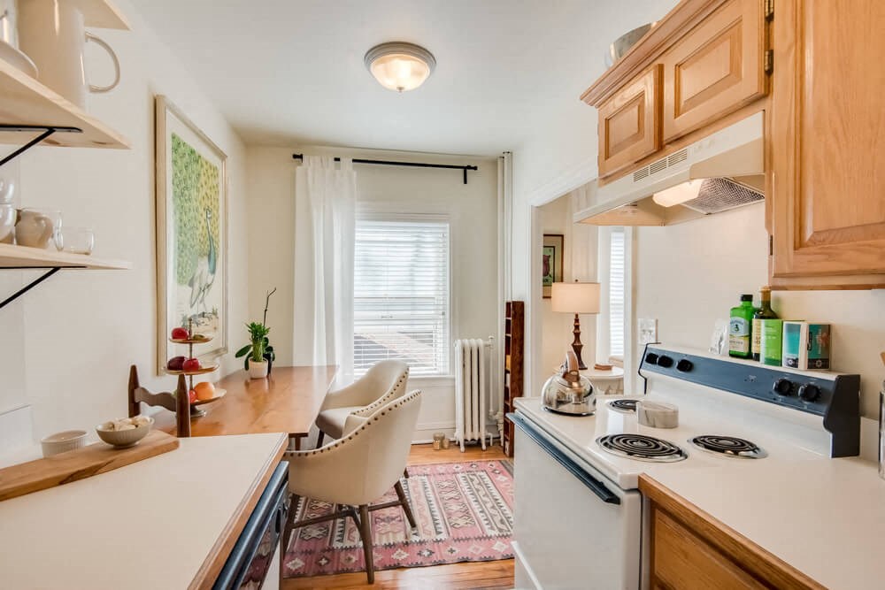 a kitchen with a stove and a sink and a window