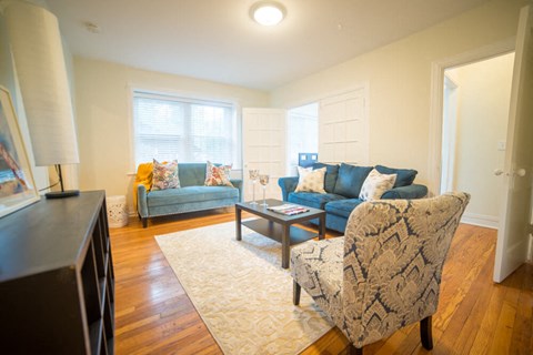 a living room with couches and chairs and a tv