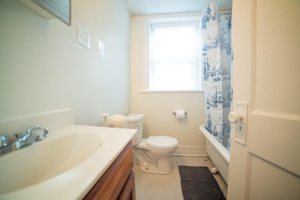 a bathroom with a toilet and a sink and a shower