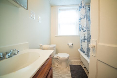 a bathroom with a toilet and a sink and a shower