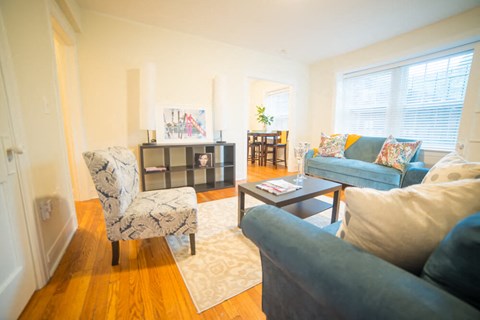 a living room with couches and chairs and a table