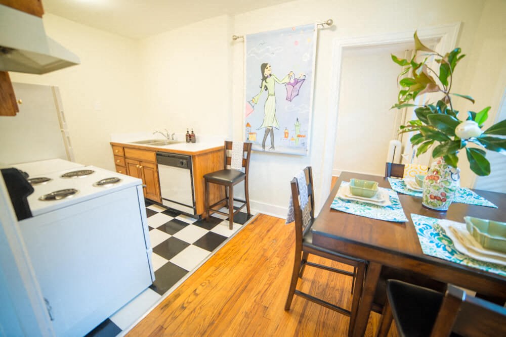 a kitchen and dining room with a table and a stove