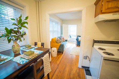 a kitchen and living room with a stove and a table