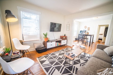 a living room with a couch and a table and a tv