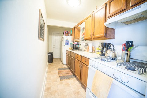 a kitchen with a stove top oven and a sink