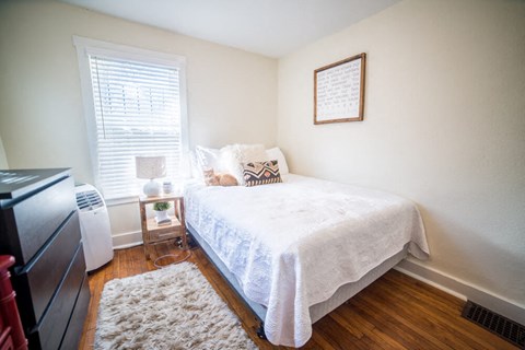 a bedroom with a bed and a tv