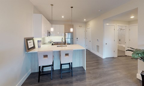a kitchen with white cabinets and a white counter top