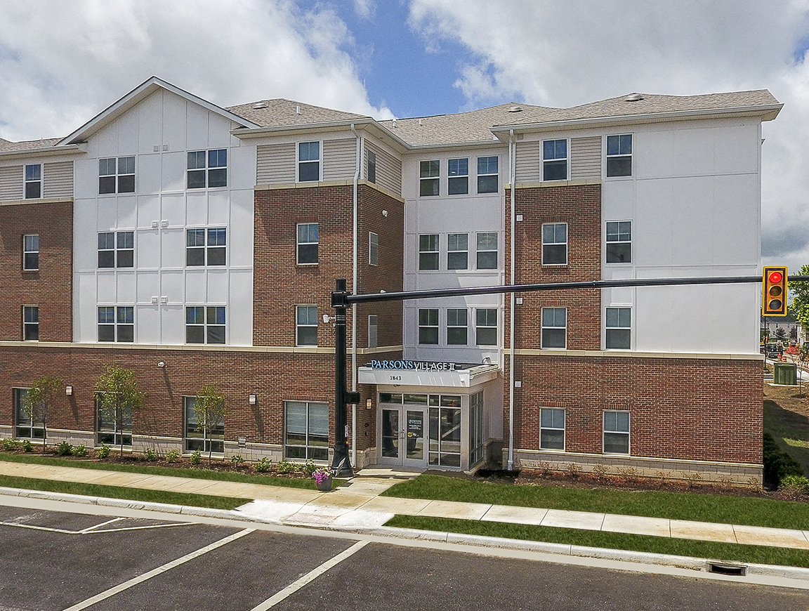 Modern apartment homes surrounded by manicured landscaping and ample parking in a thoughtfully designed community setting.