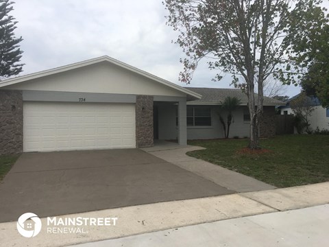 the front of a house with a driveway and a garage door