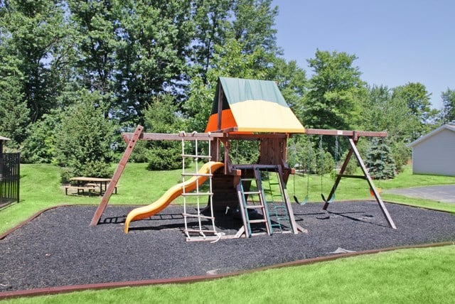 a playground with a swing set and a slide
