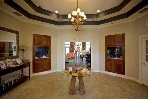 a dining room with a glass table and a chandelier