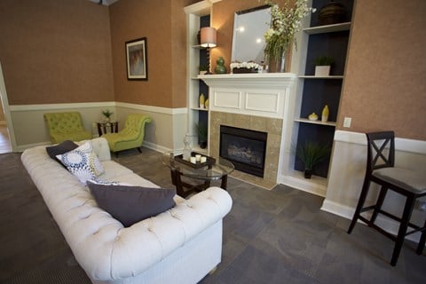 a living room with a white couch and a fireplace