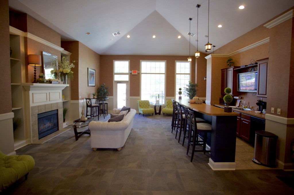 an open living room with a fireplace and a bar