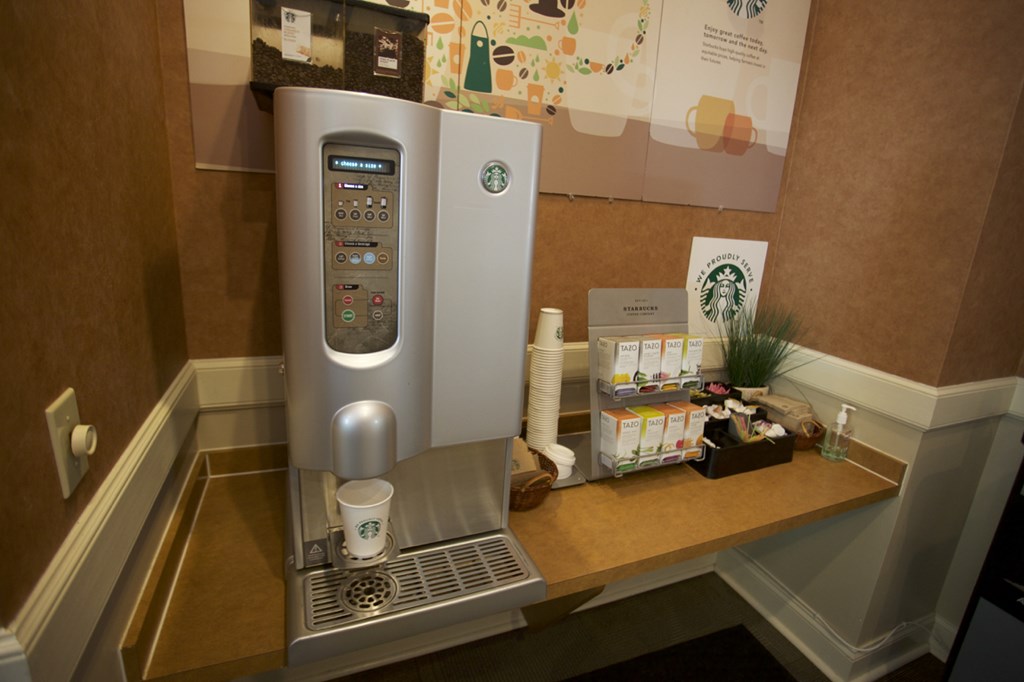 a coffee machine on a desk in a hotel room