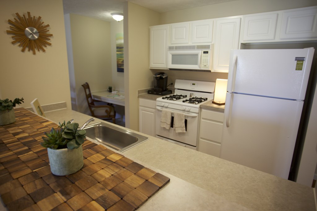 a kitchen with white appliances and a counter top