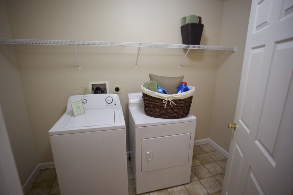 a laundry room with a washer and dryer and a basket