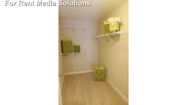 a room with a closet and shelves with boxes