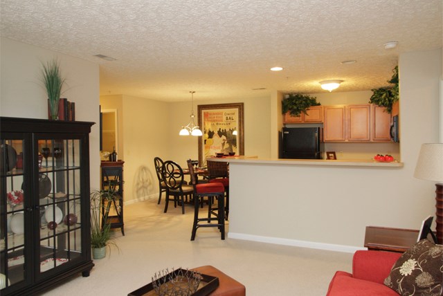 an open living room and kitchen with a bar and a dining area