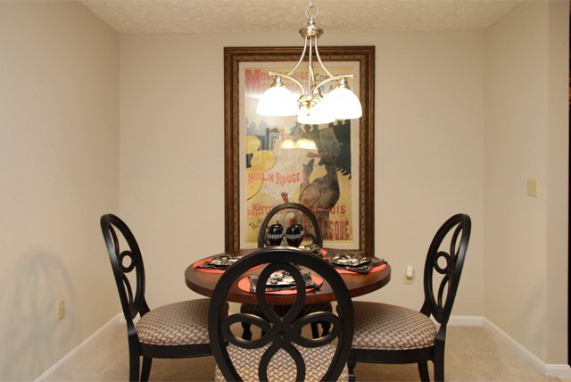 a dining room with a table and chairs and a chandelier