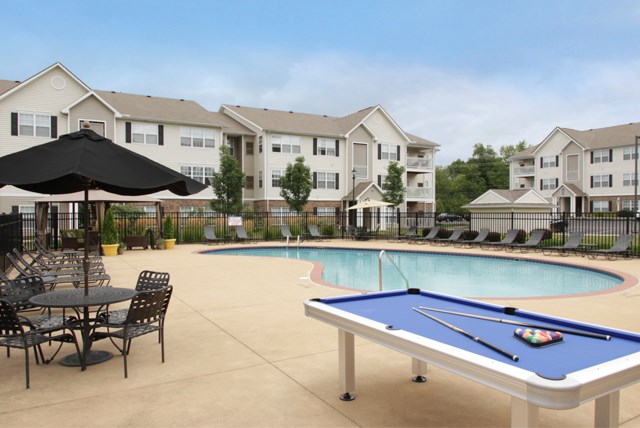 our community pool and tables with our apartments in the background