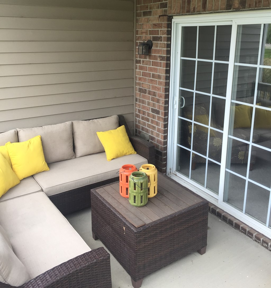 a patio with a couch and a coffee table