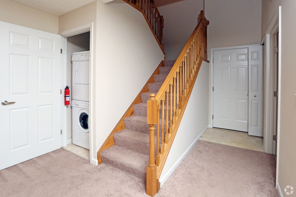 a staircase in a home with a washer and dryer