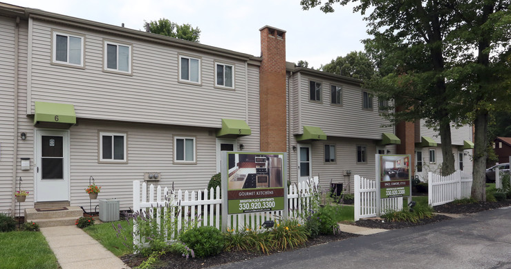 a white house with a sign in front of it