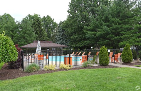 a swimming pool with a fence and a gazebo