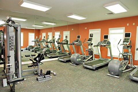 a gym with cardio machines and other exercise equipment