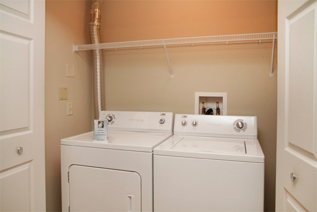 the washer and dryer in the laundry room of a home