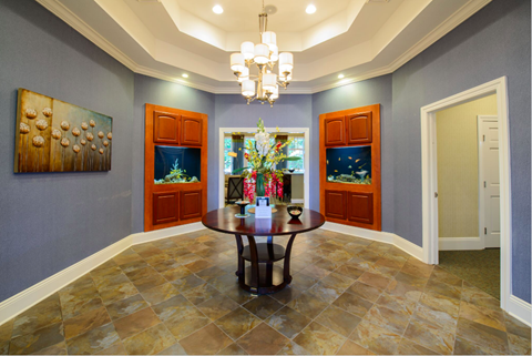 a dining room with a table and a fish tank