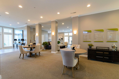 A spacious room with a dining table and chairs.