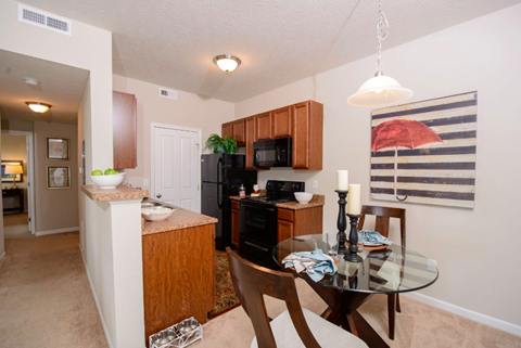 A kitchen with a table and chairs in the middle of the room.