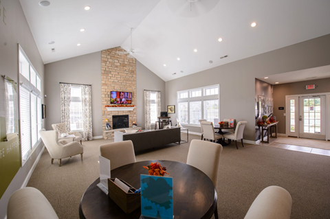 A living room with a fireplace and a television on the wall.