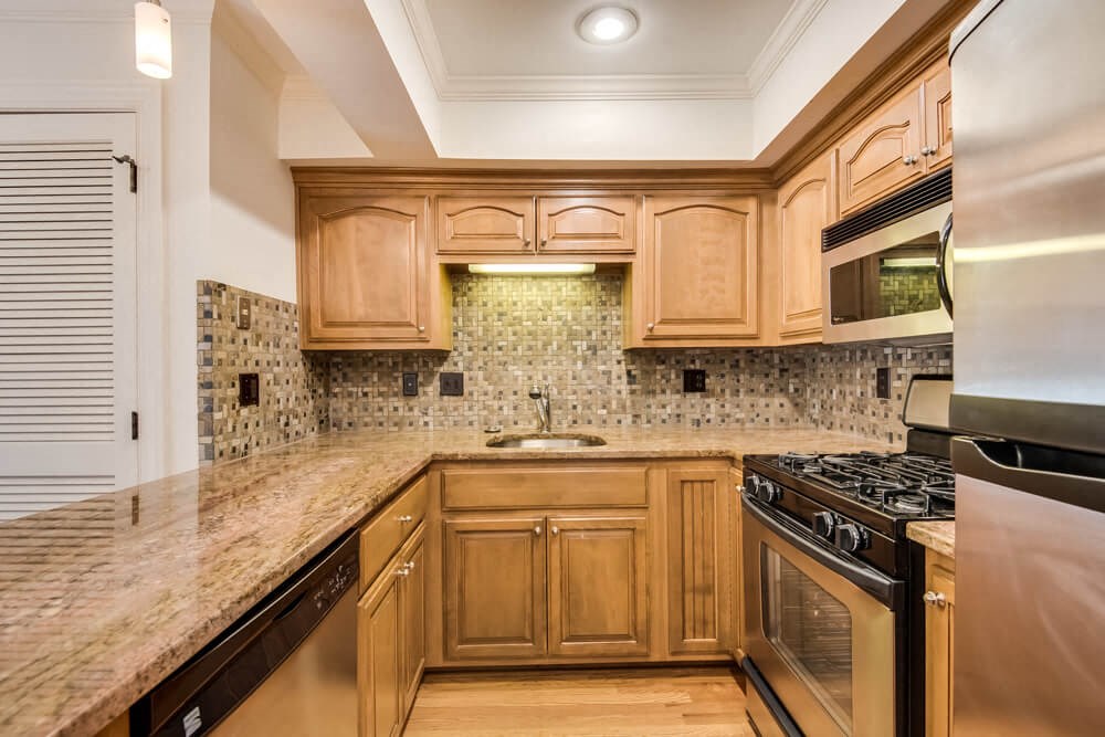 a kitchen with wooden cabinets and a counter top