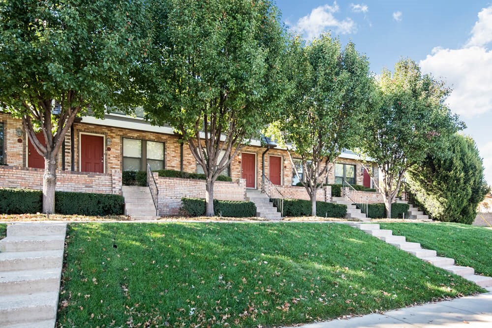 a row of houses with trees in front of them