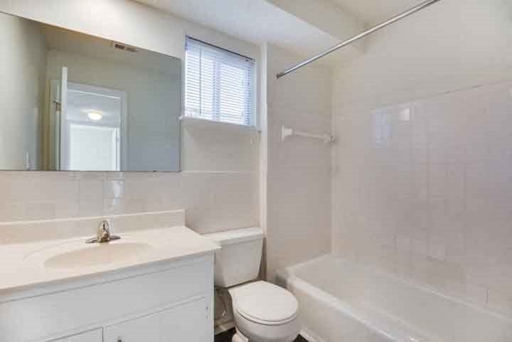 a bathroom with a sink toilet and a bath tub