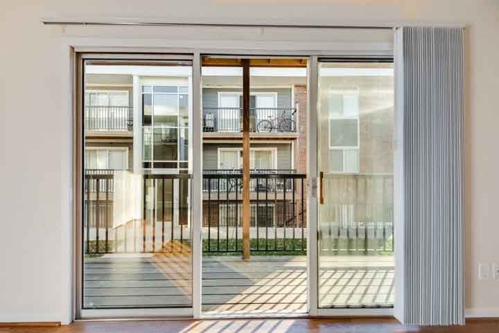 a large glass door with a balcony in a building
